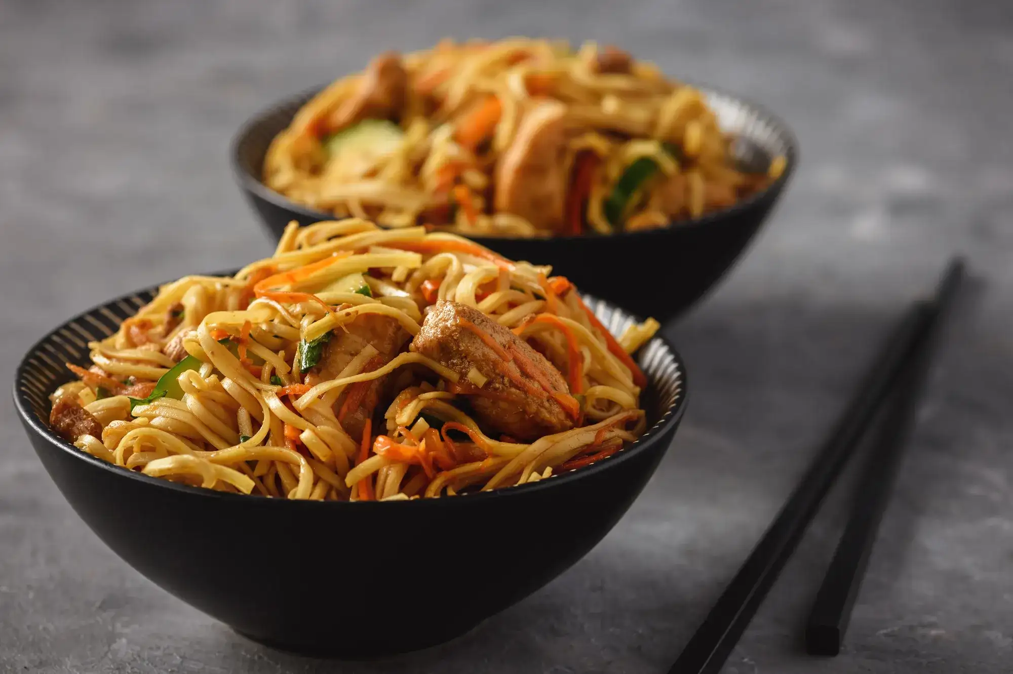 Bowls of noodles plated