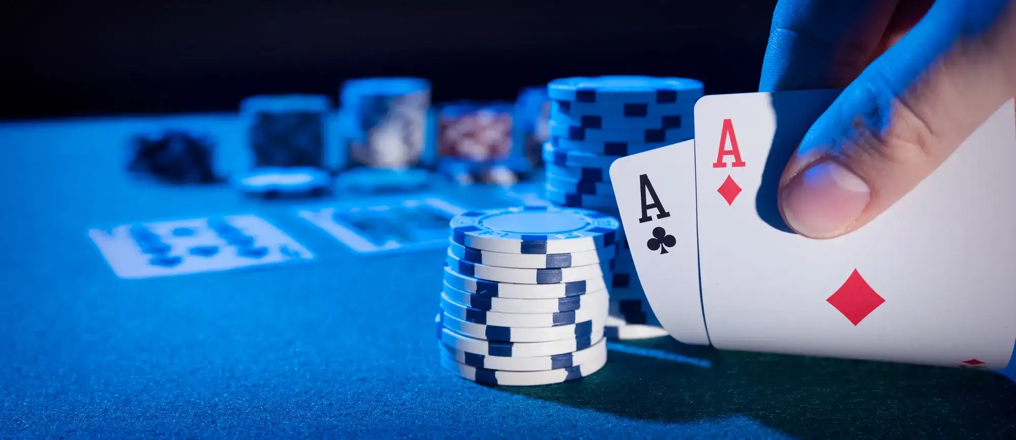 Pocket aces and poker chips on a blue felt table during a Las Vegas poker tournament