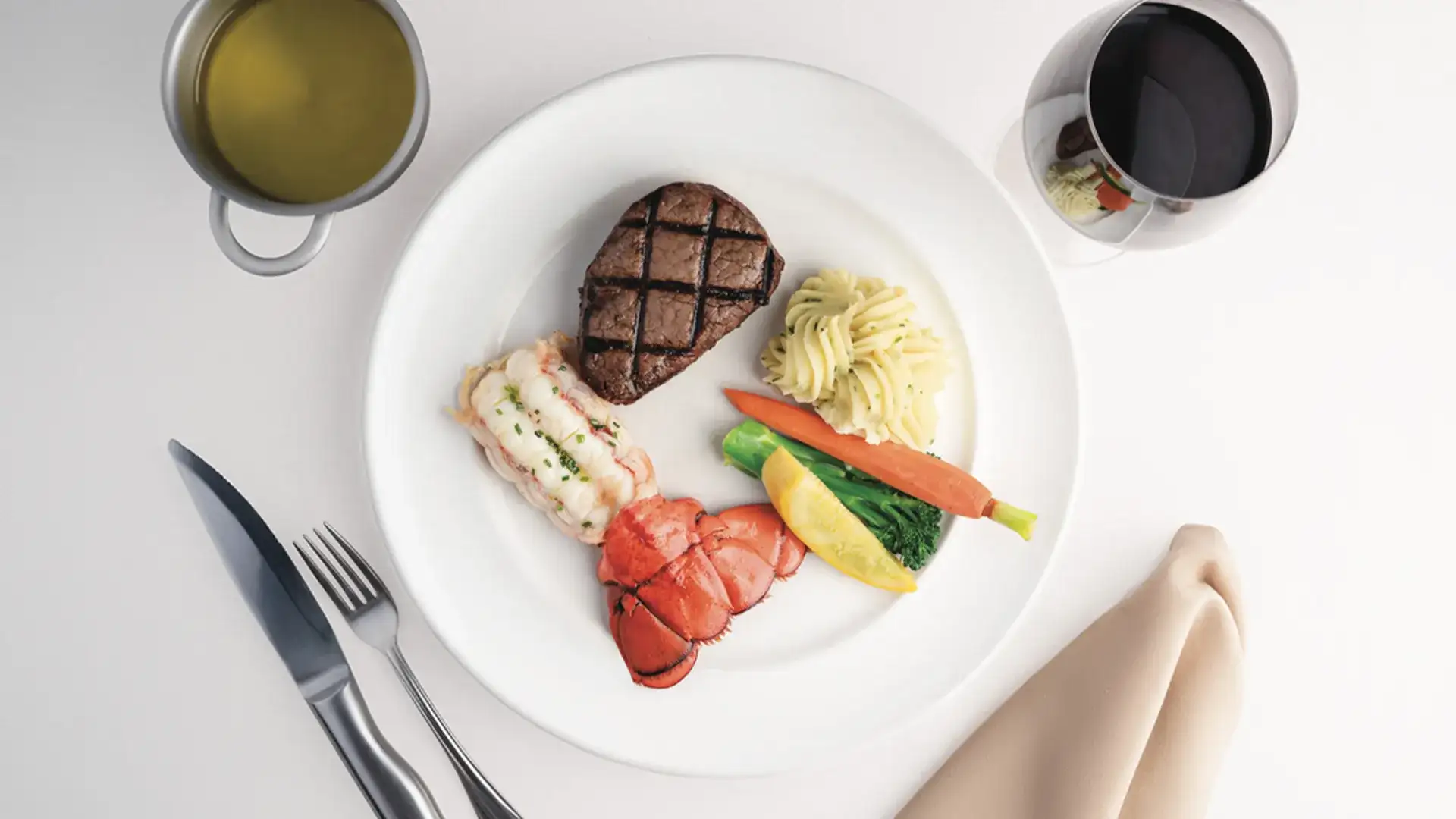 Lobster tail & steak served with vegetables