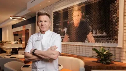 Celebrity Chef Gordon Ramsay posing in his restaurant.