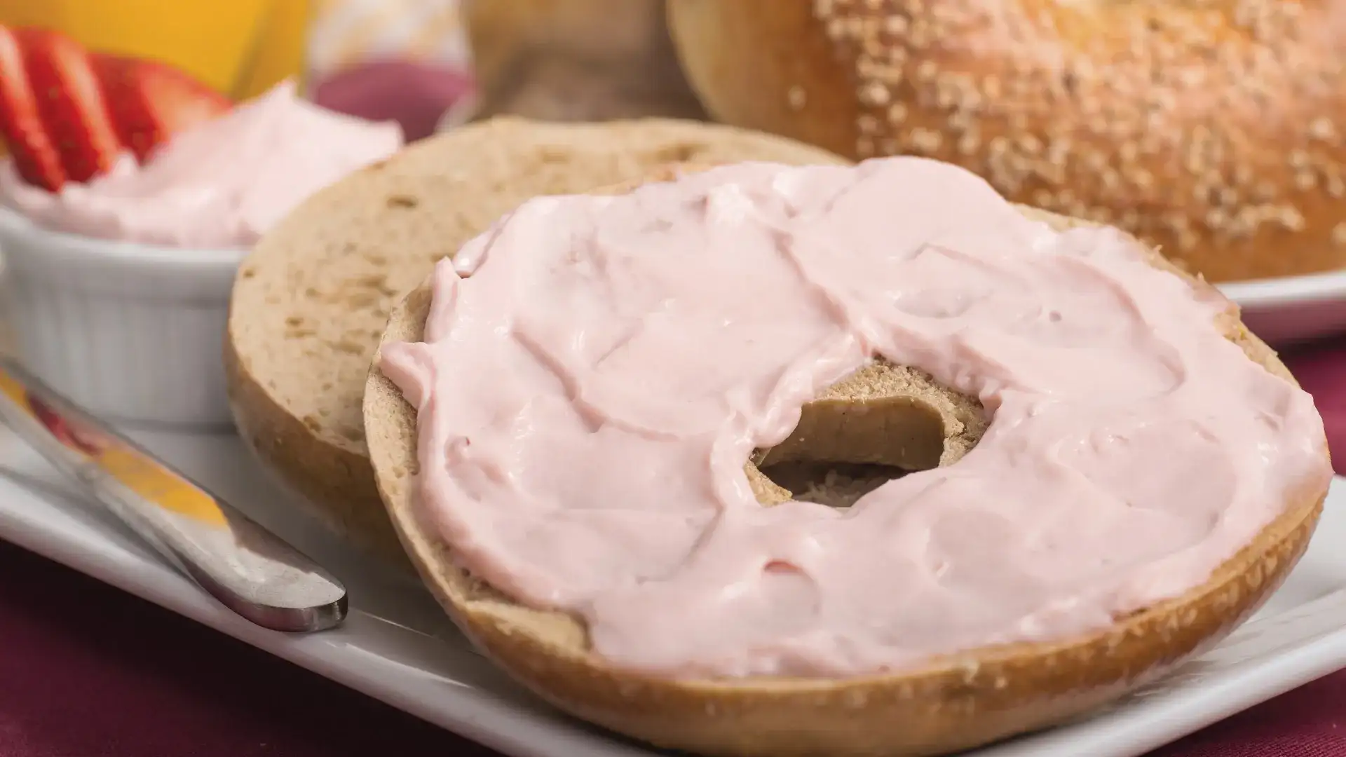Bagel with fruity cream cheese spread.