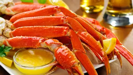 King crab legs with butter and lemon garnish.