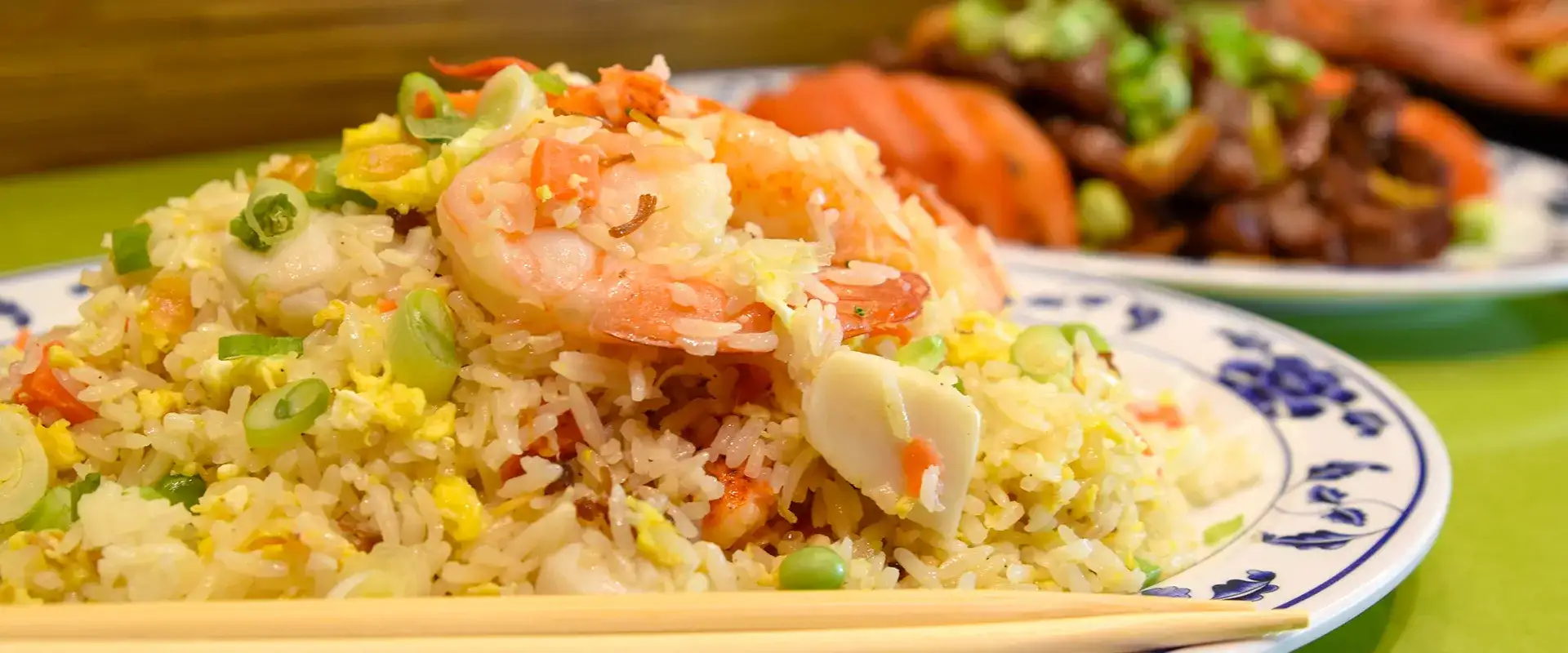 Shrimp and chicken fried rice with chopsticks.