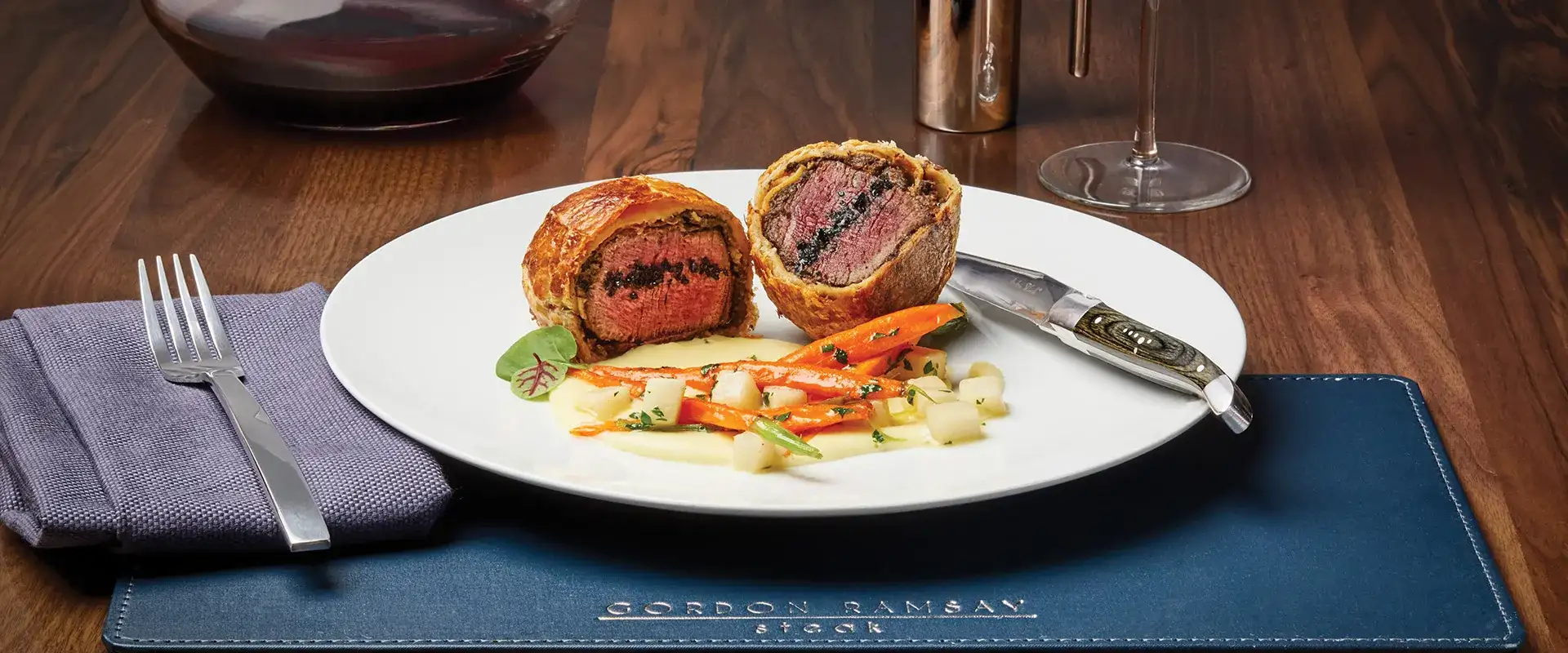 Beef Wellington, root vegetables, and potato puree.