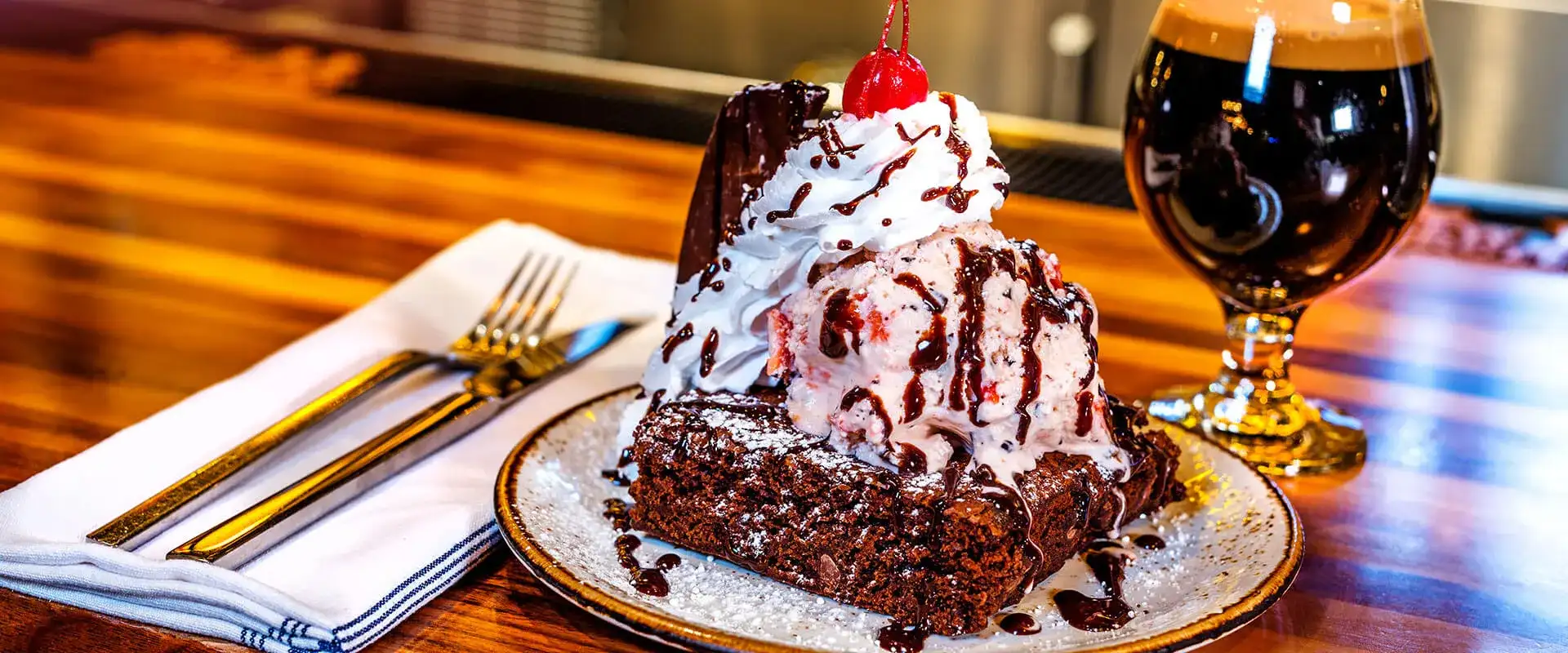 Warm brownie sundae with ice cream and a pint of stout.