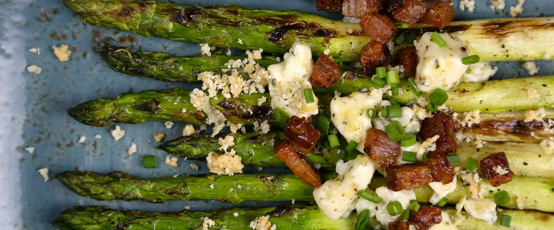 Asparagus topped with bacon and blue cheese.