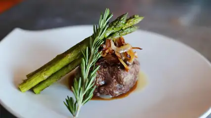 Filet with a side of asparagus on a plate.