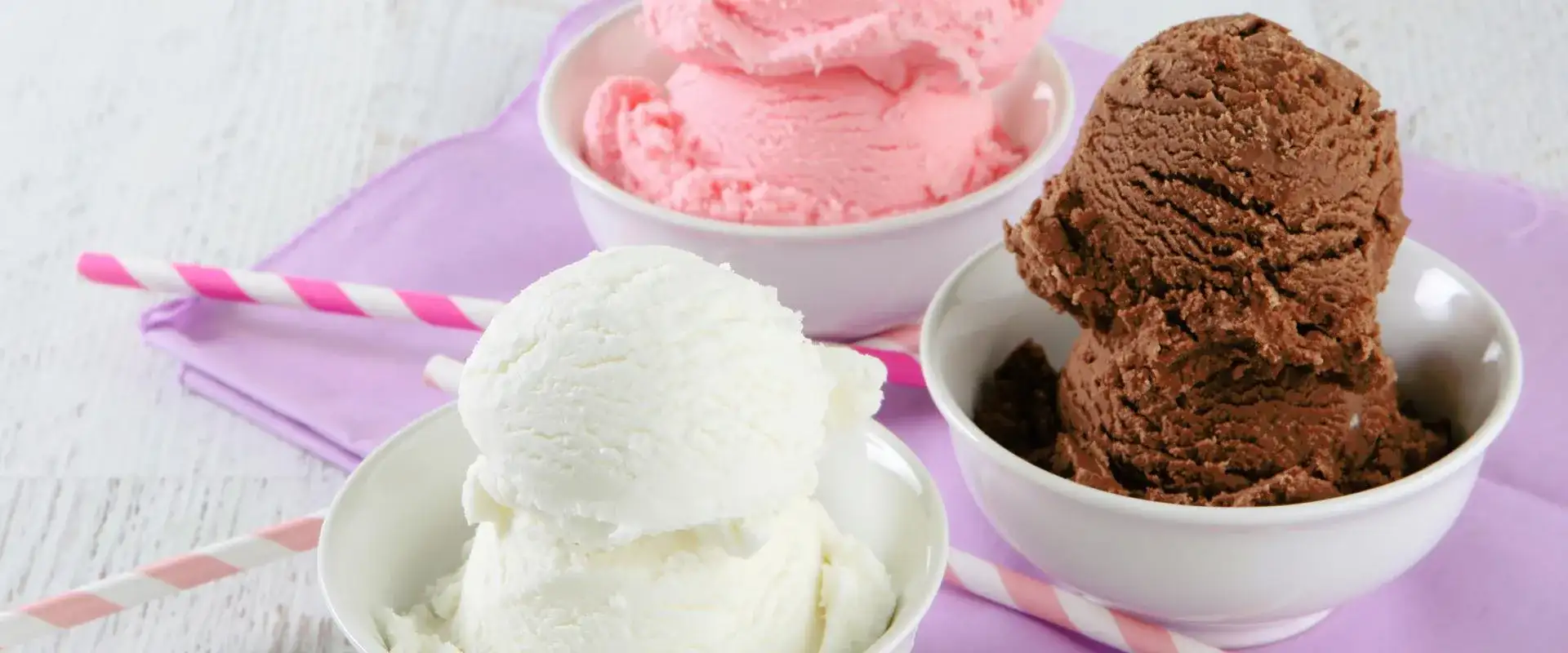 Chocolate, Vanilla and Strawberry ice cream scoops in bowls