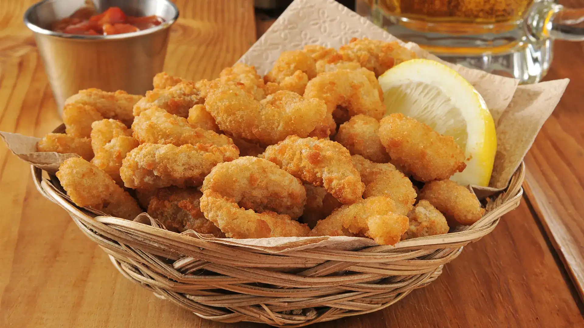 Fried shrimp in a basket with cocktail sauce
