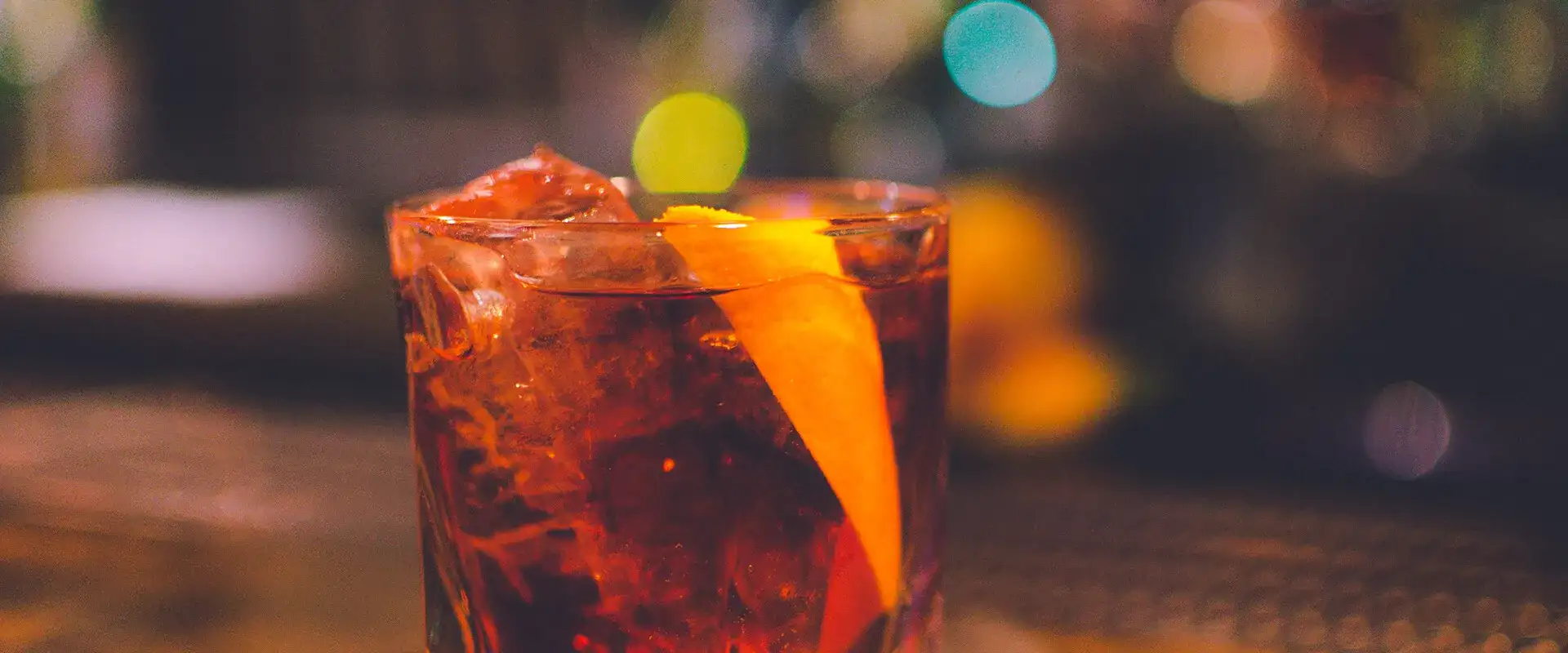 Cocktail with an Organge garnish.
