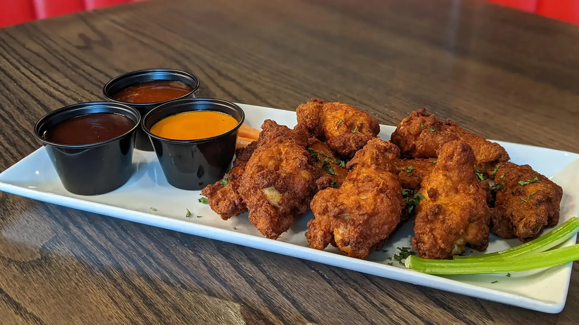 Philly Tap & Tavern chicken wings, dipping sauces, and crudité.