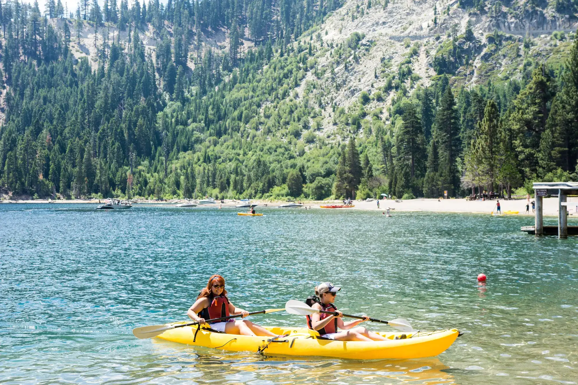 Family enjoying summer kayaking on Lake Tahoe near the Stateline resort corridor in South Lake Tahoe.