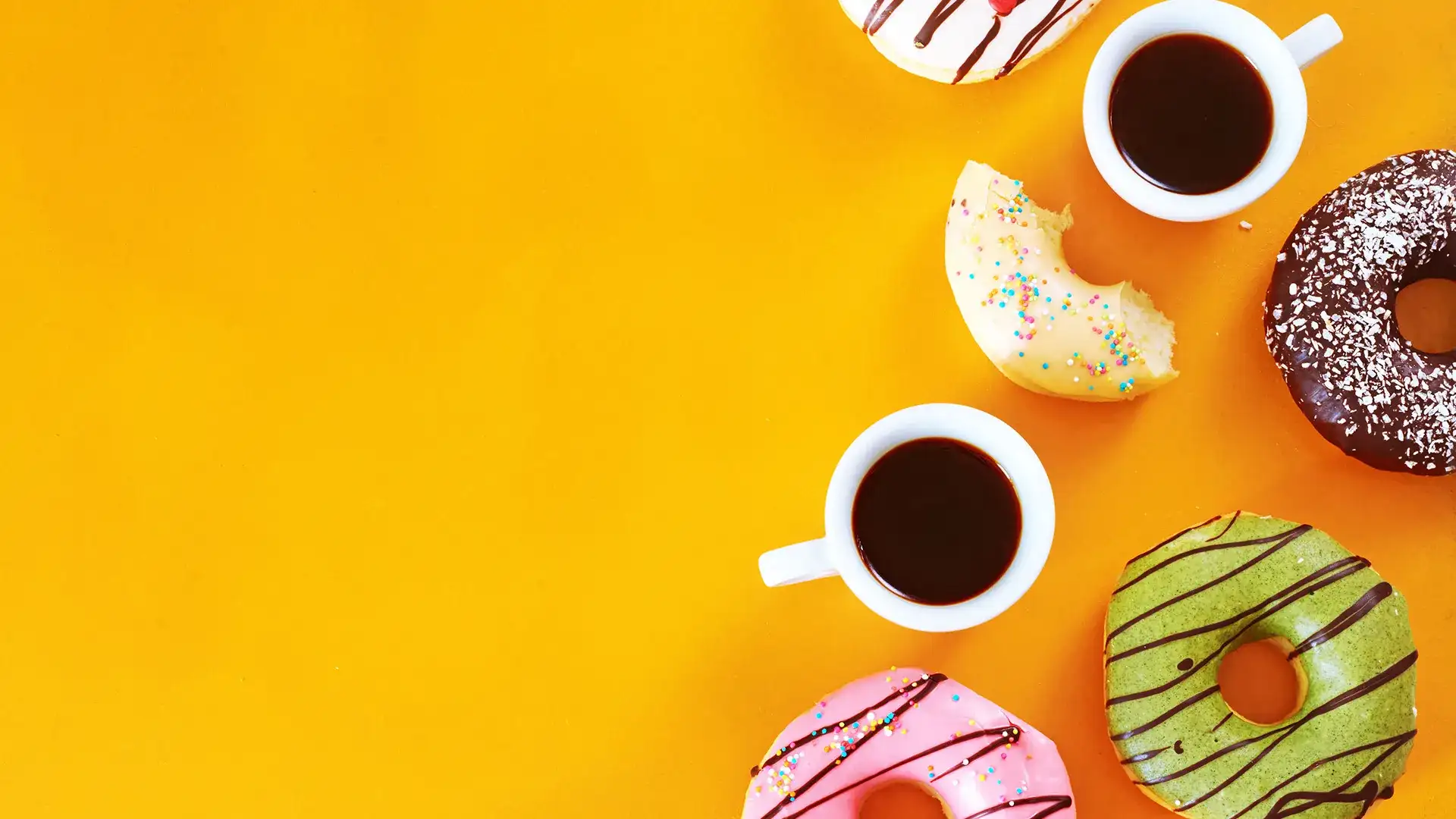 Donuts and mugs of coffee on a yellow background.