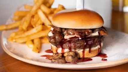 Brew Brothers Mushroom Burger plated next to fries.