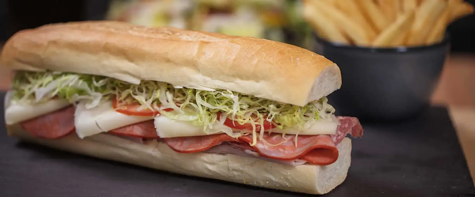 Sub sandwich with meat, cheese and fresh vegetables.