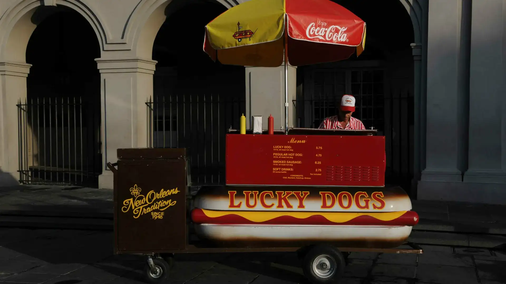 Lucky Dogs hot dog stand in front of a building.