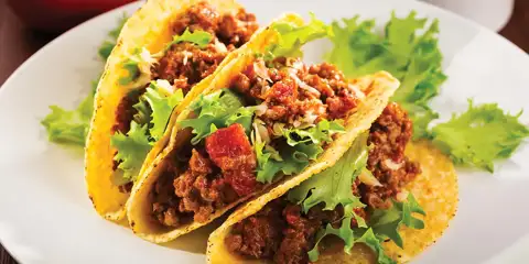 Three tacos on a plate.