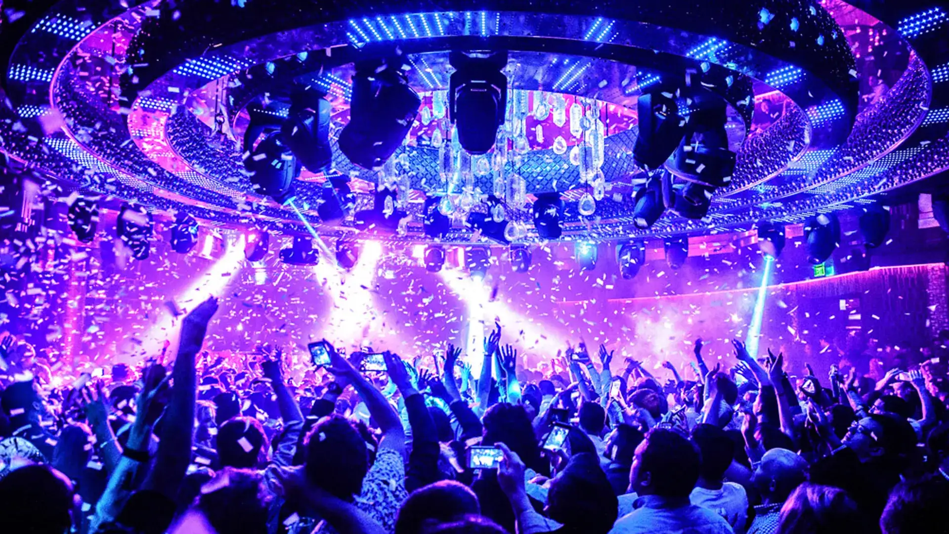 OMNIA Nightclub at Caesars Palace with massive chandelier, confetti, laser lights and a packed dance floor