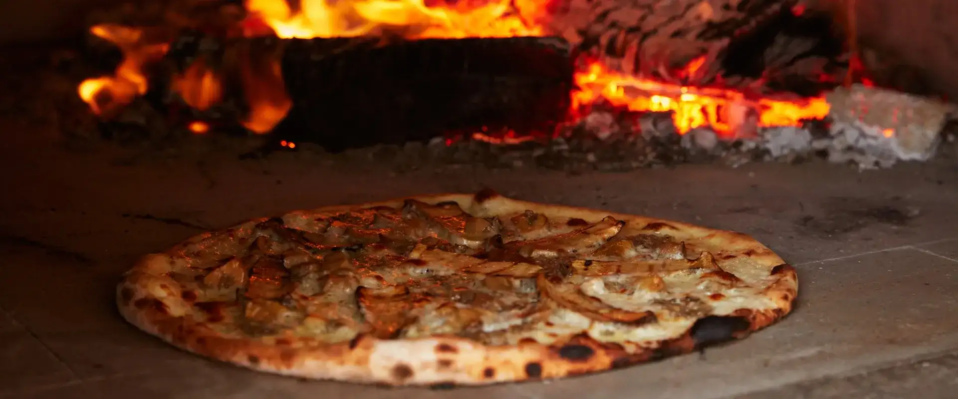 Pizza baking in a wood-fired oven.