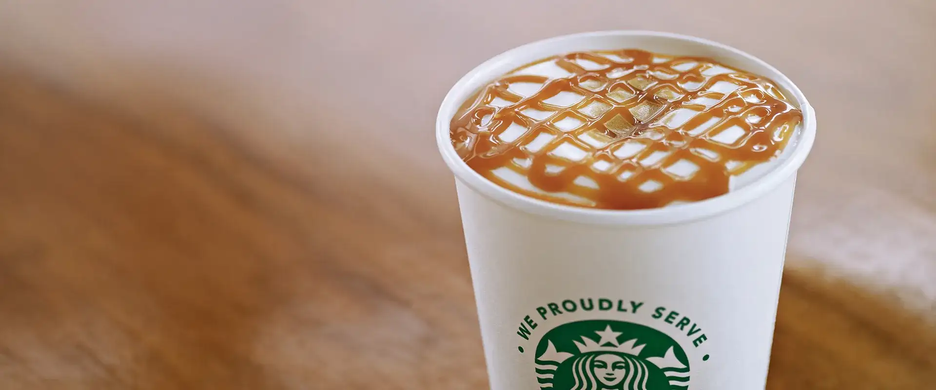 Starbucks to-go drink with caramel topping.