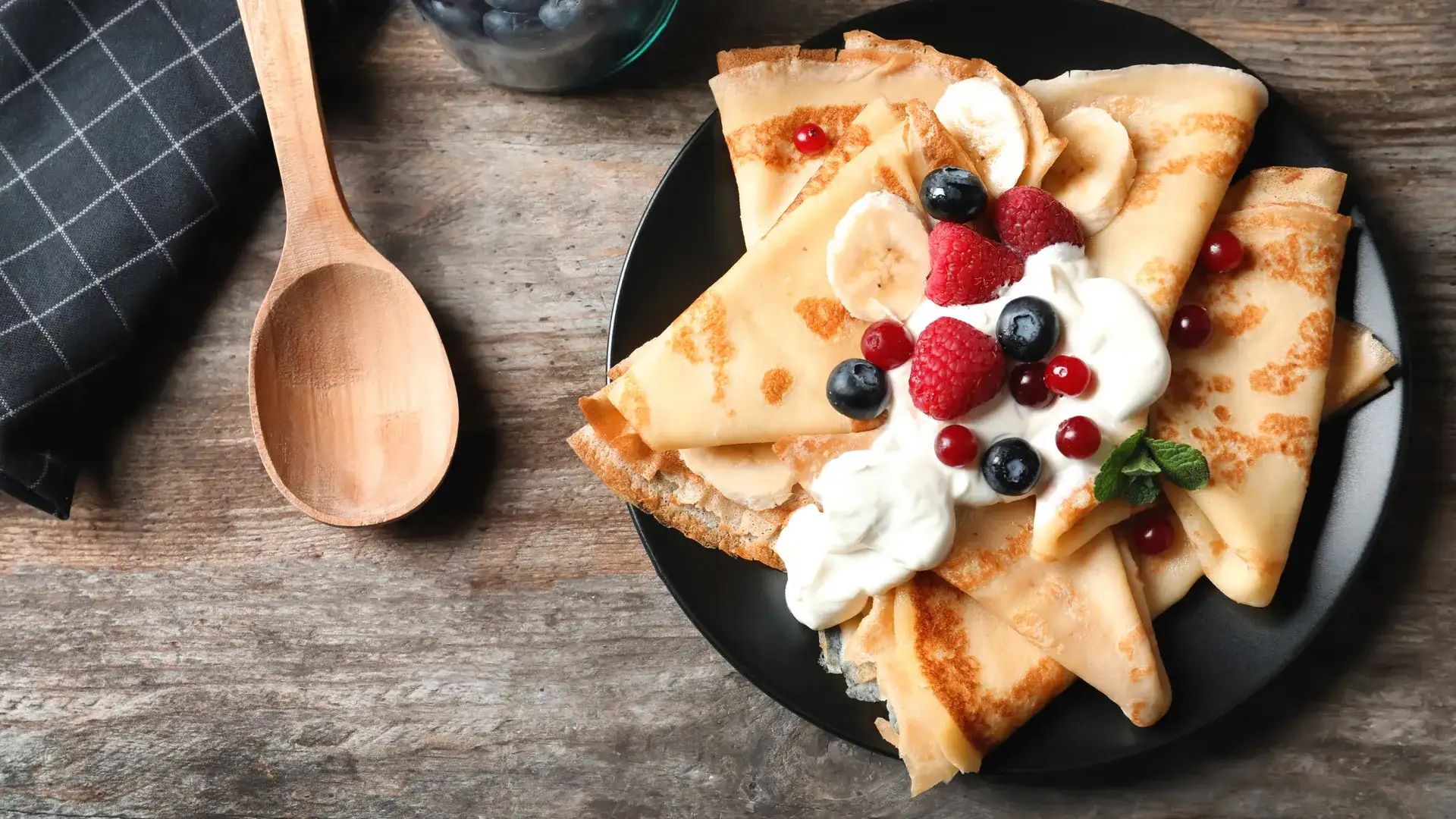 Crepes with fresh berries and whip cream.