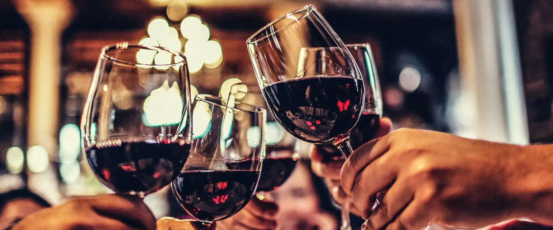 Toasting cheers with glasses of red wine.