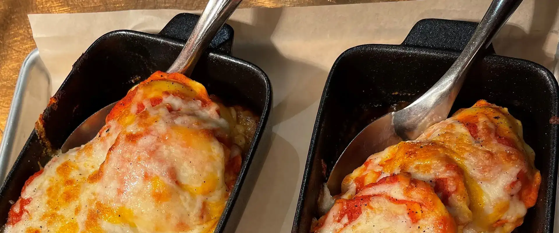 Baked ravioli in cast iron dishes.