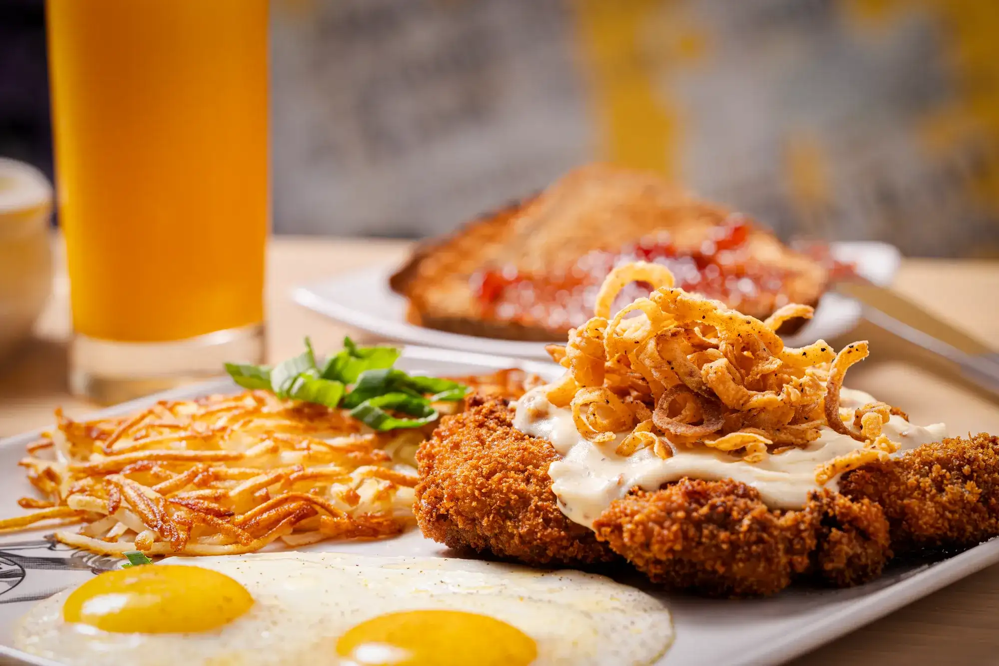 Guy Fieri's Ktichen + Bar at Harrah's Council Bluffs.  Chicken Fried Steak, hash browns, eggs, toast, orange juice.  Shot May 2024