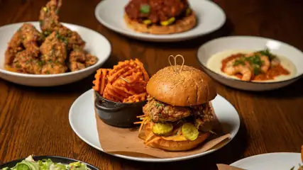 Burgers with fries, wings, shrimp & grits, waffles