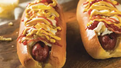Two hot dogs with assorted toppings.