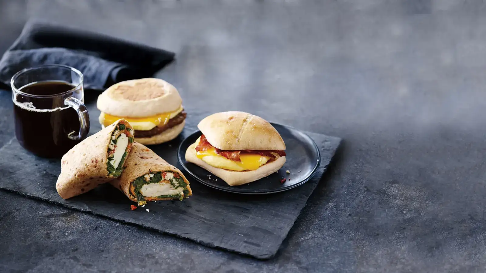 Sandwiches and wrap with a hot coffee.