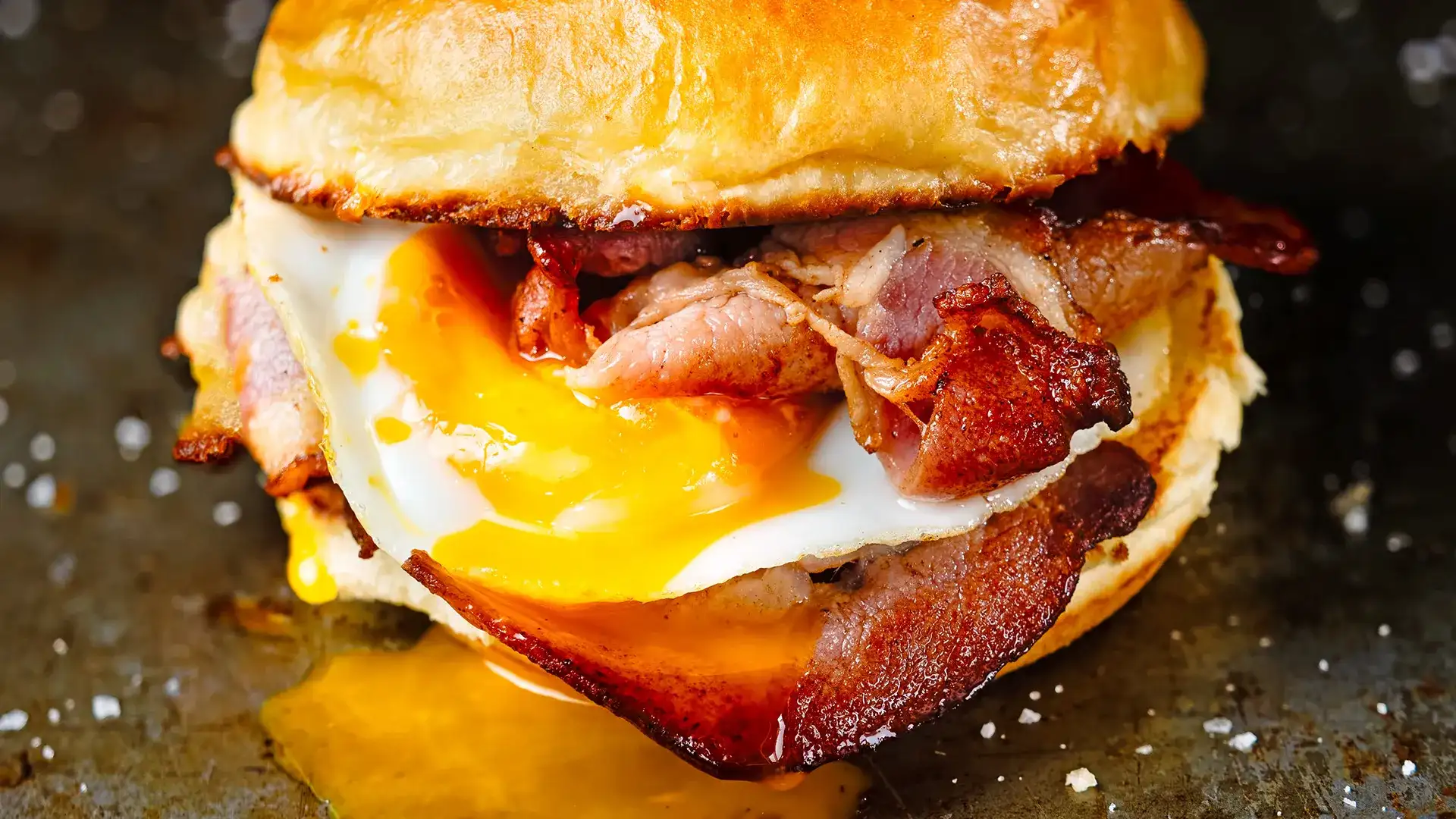 Breakfast sandwich with bacon and a fried egg