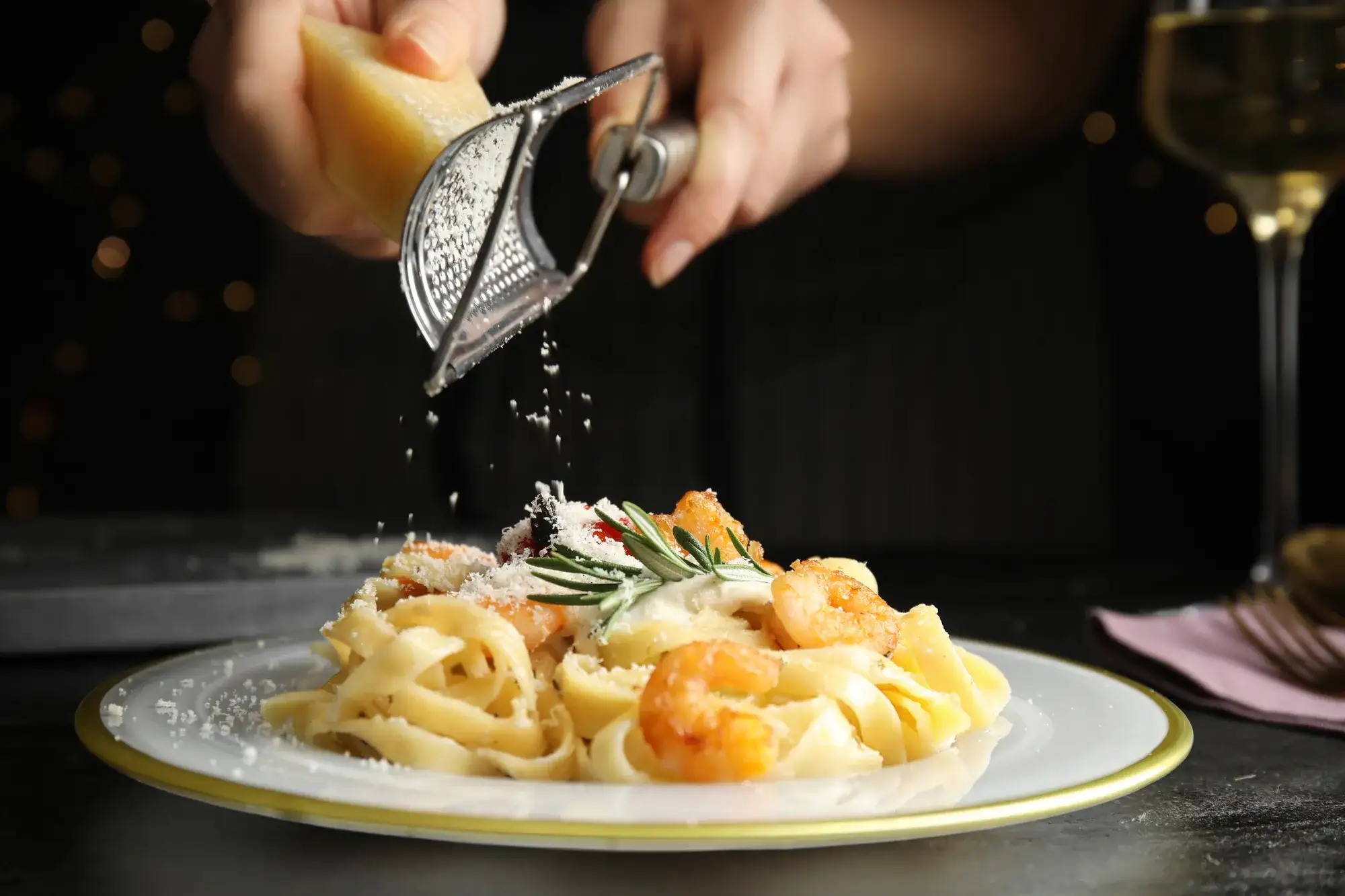 Pasta dish with cheese being grated over it