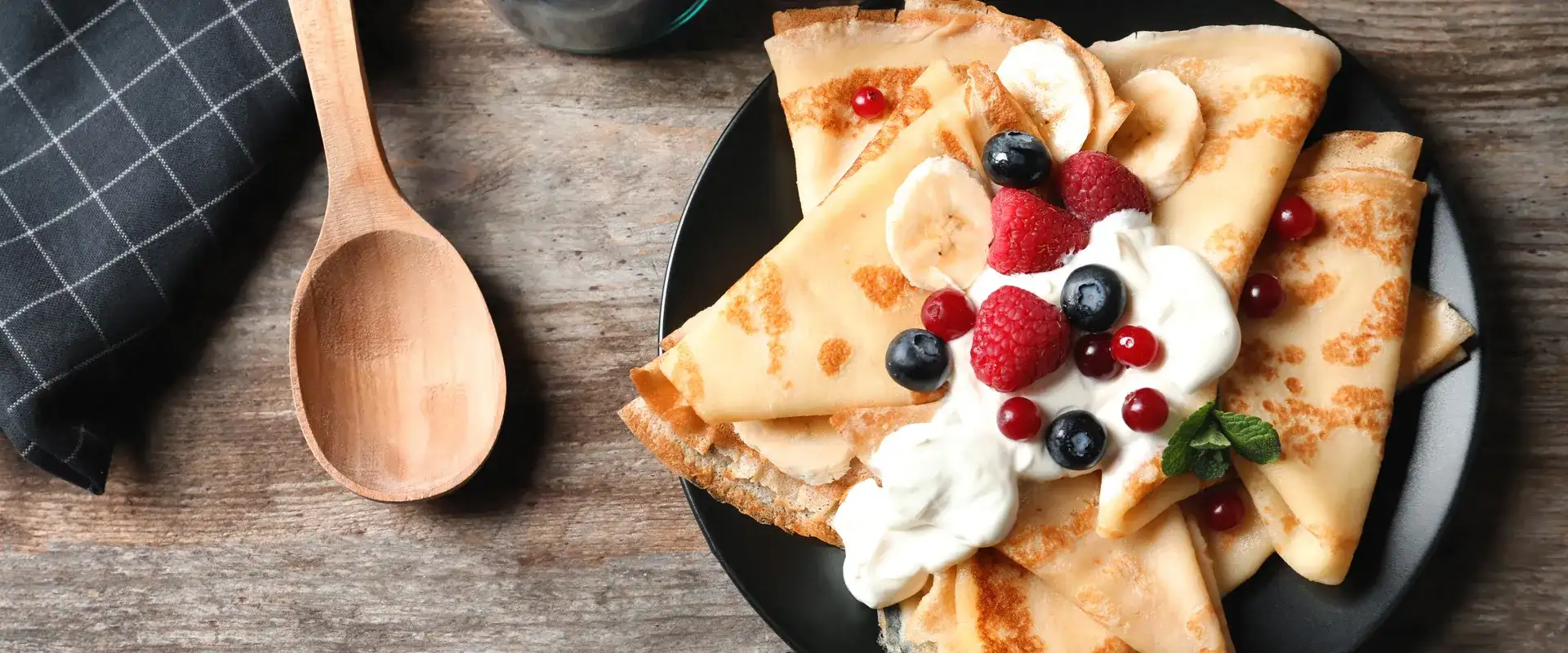 Crepes with fresh berries and whip cream.