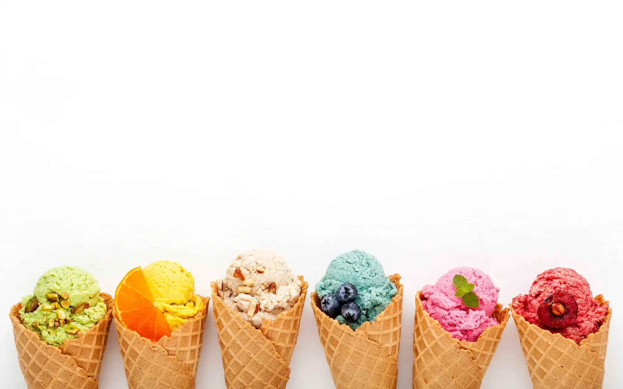 Various of ice cream flavor in cones blueberry ,strawberry ,pistachio ,almond ,orange and cherry setup on white wooden background . Summer and Sweet menu concept.