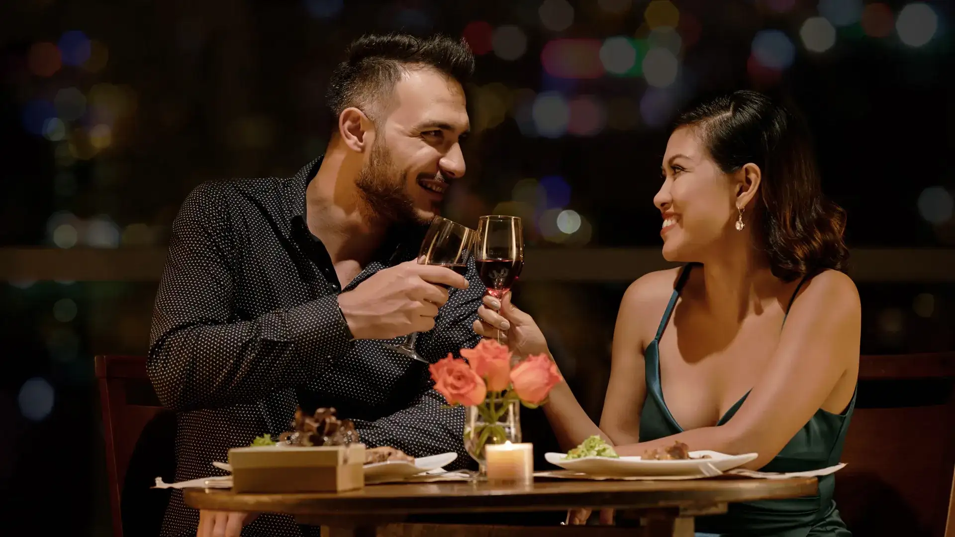 Couple toasting wine at romantic dinner.