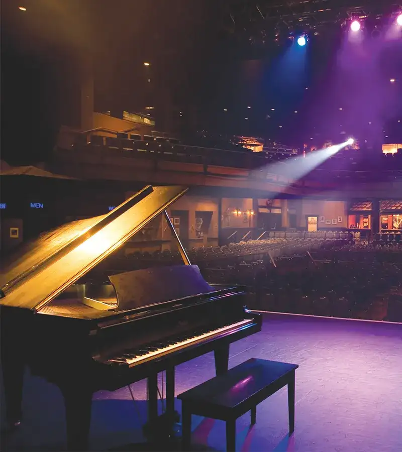 Bluesville Showcase Nightclub stage with piano, looking out to venue seating.