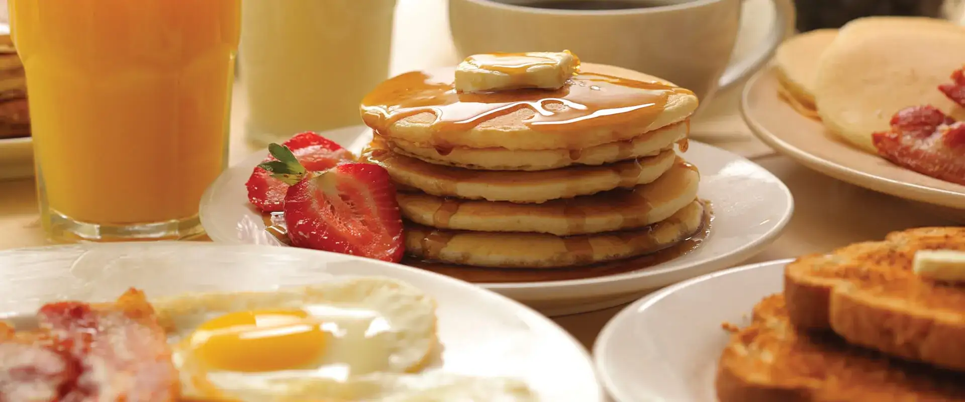 Assortment of traditional breakfast entrees and juice.