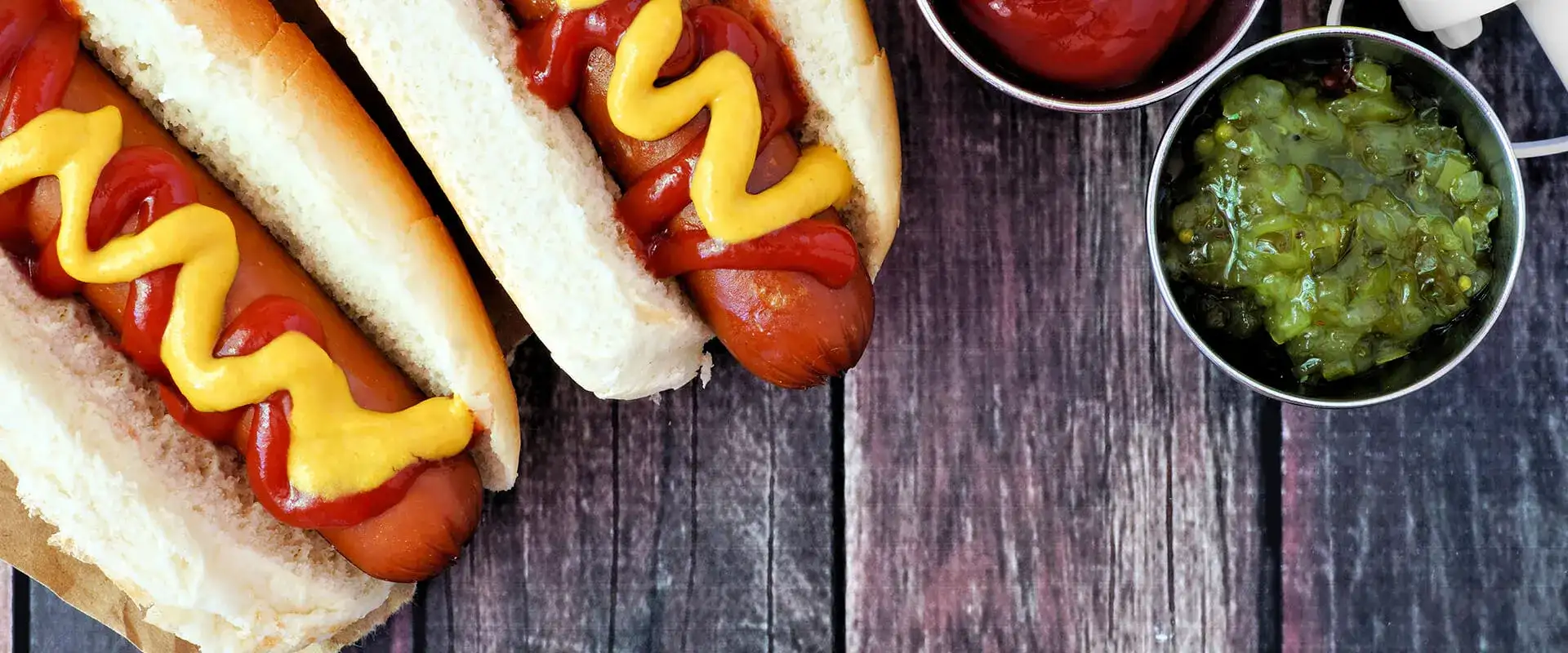 Hot dog on a bun with ketchup and mustard.