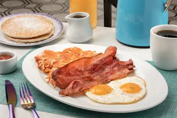 Grand Breakfast - Two eggs any style, sausage and bacon, hash browns, choice of two pancakes or French toast