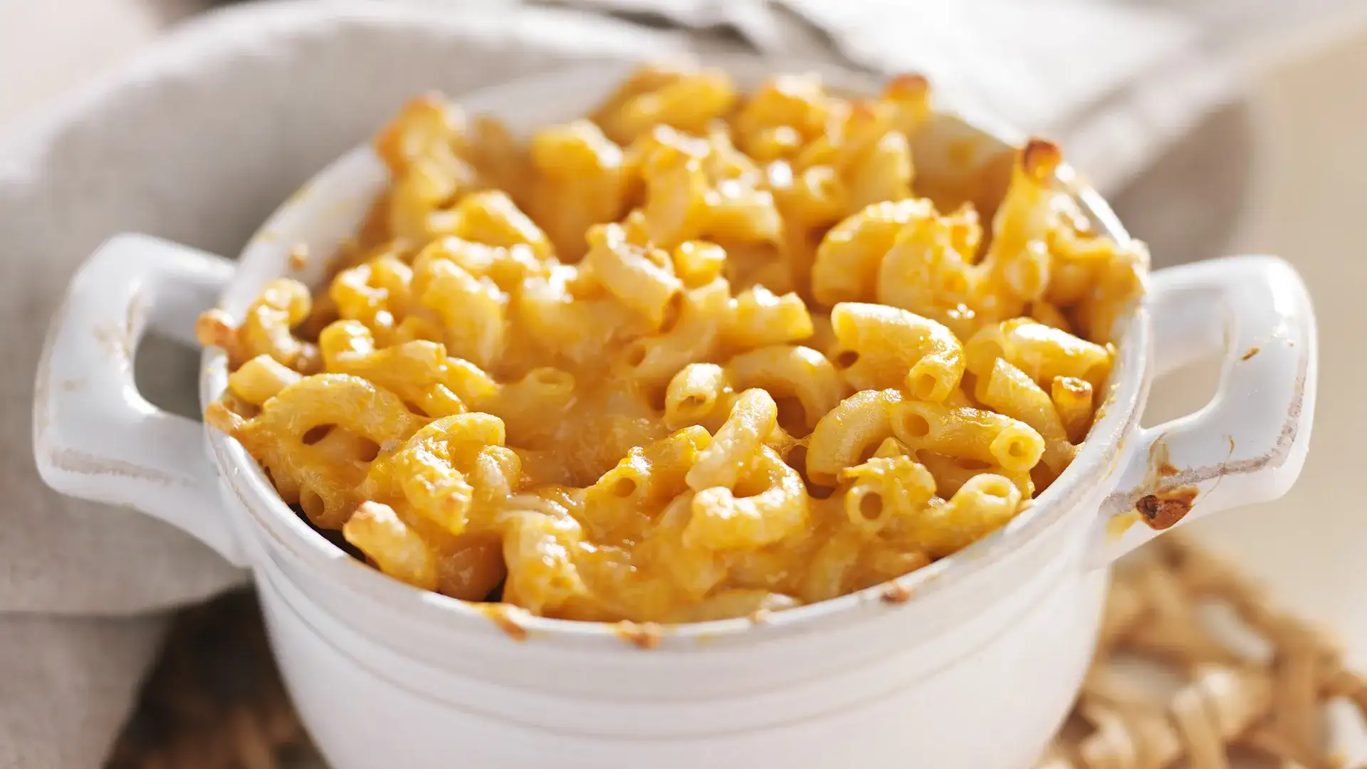 Macaroni and cheese in a ceramic dish.