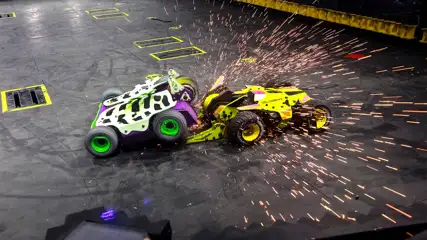 Green and White Tank attacking a Yellow Tank at Battle Bots at Horseshoe Las Vegas. Sparks Flying in the air during the attack.