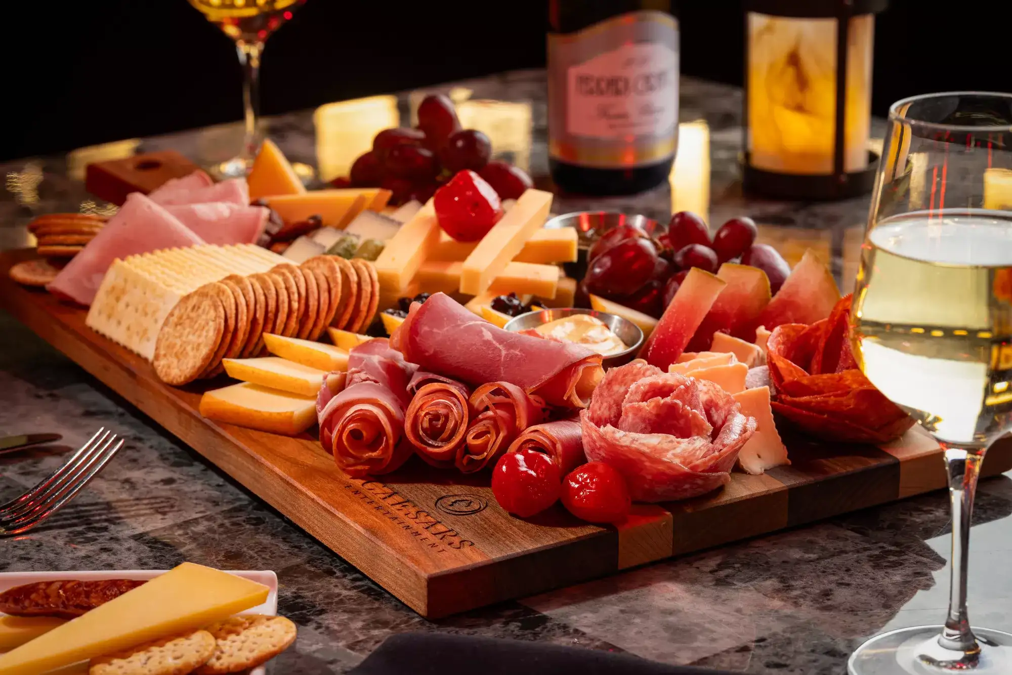 Casa Di Amici board with sliced meats, cheeses, and crackers.
