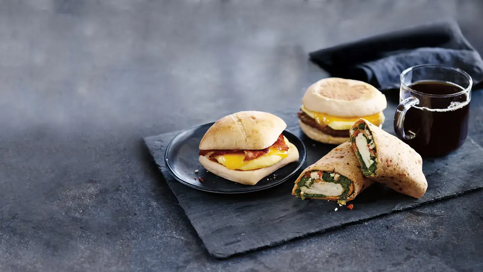 Sandwiches and wrap with a hot coffee.