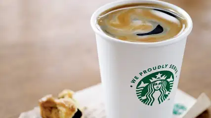 Americano from Starbucks next to a pastry.