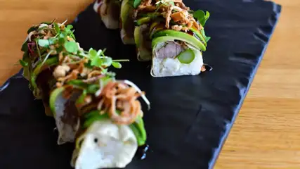 Sushi rolls on a plate.