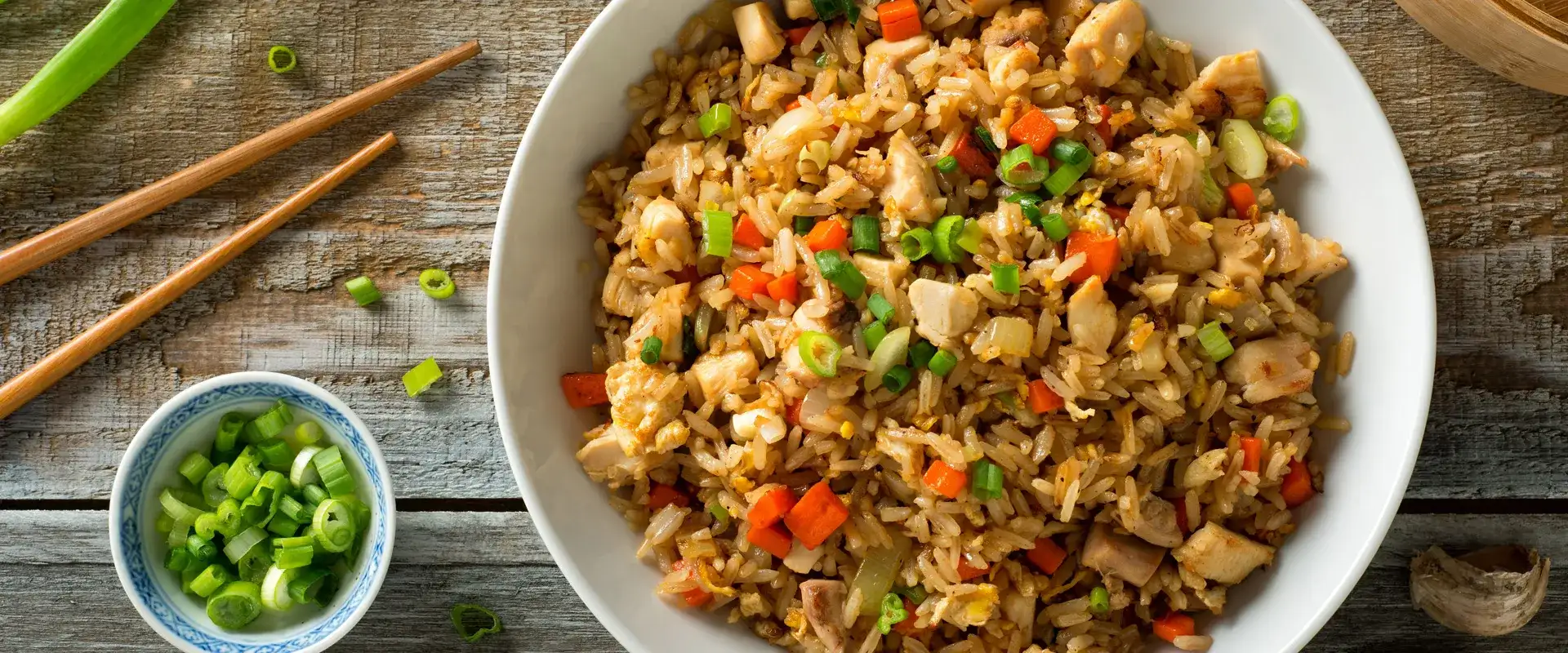 Fried rice with carrot onion and egg in a bowl.