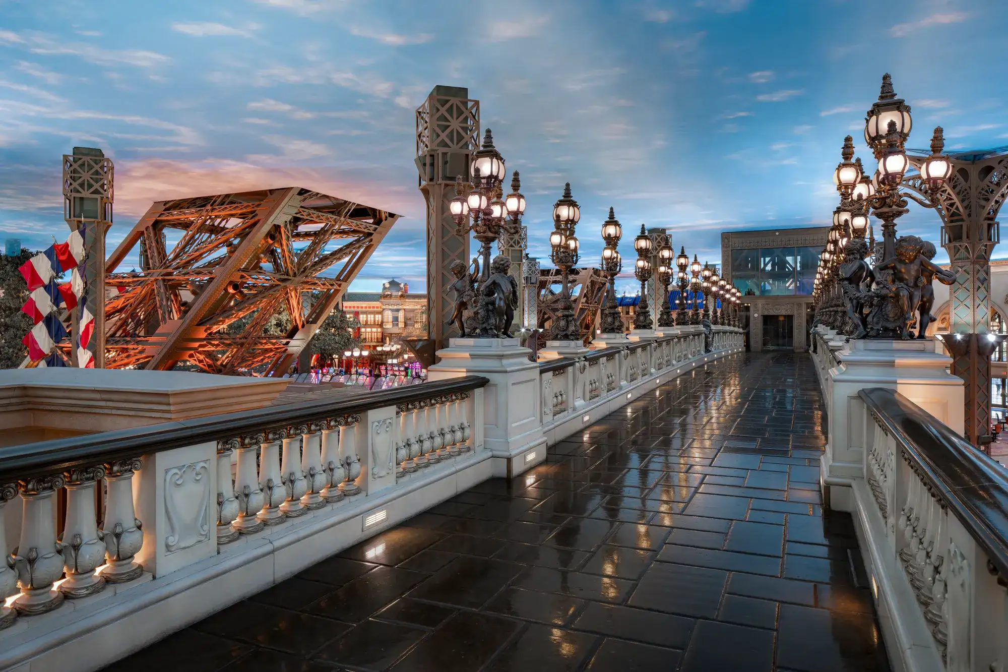 Eiffel Tower Bridge at Paris Las Vegas lined with ornate lamps and statues beside the Eiffel Tower replica
