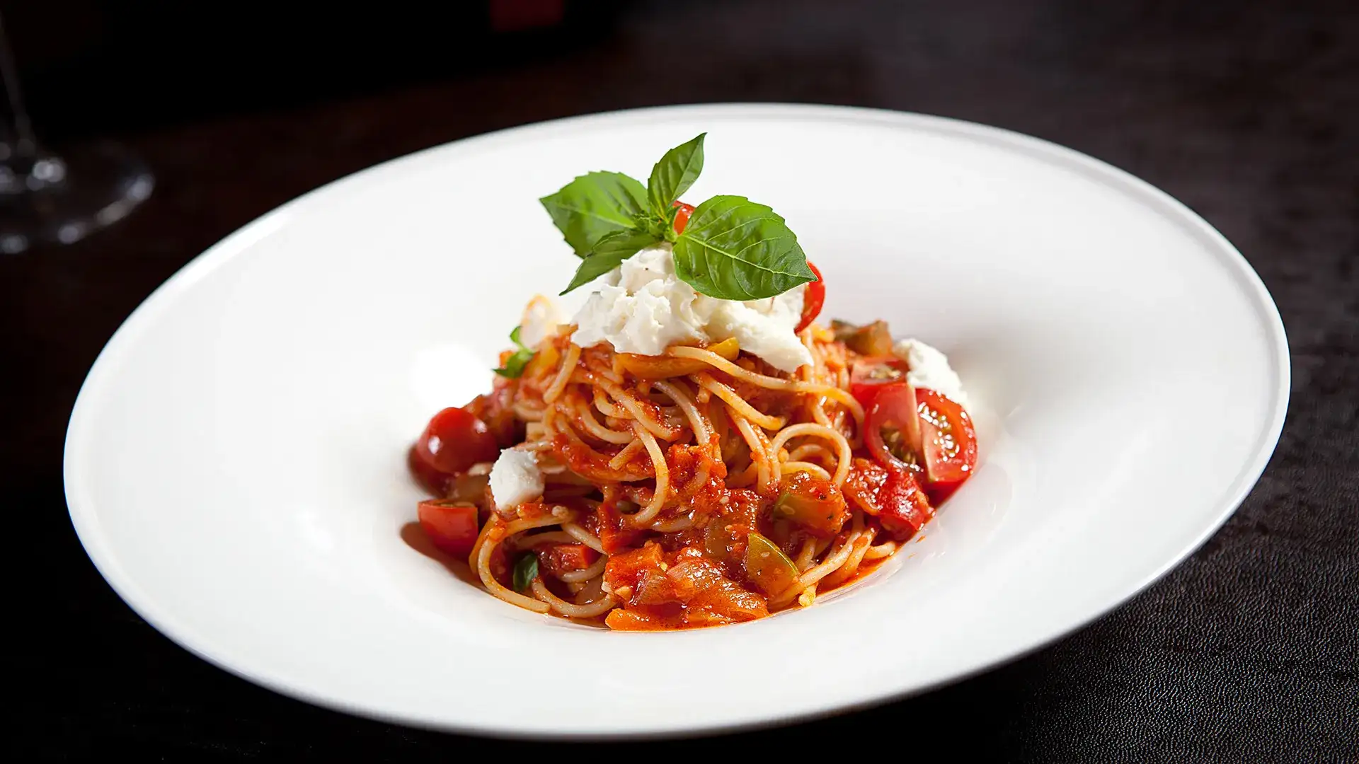Spaghetti with tomato sauce, mozzarella, and basil.
