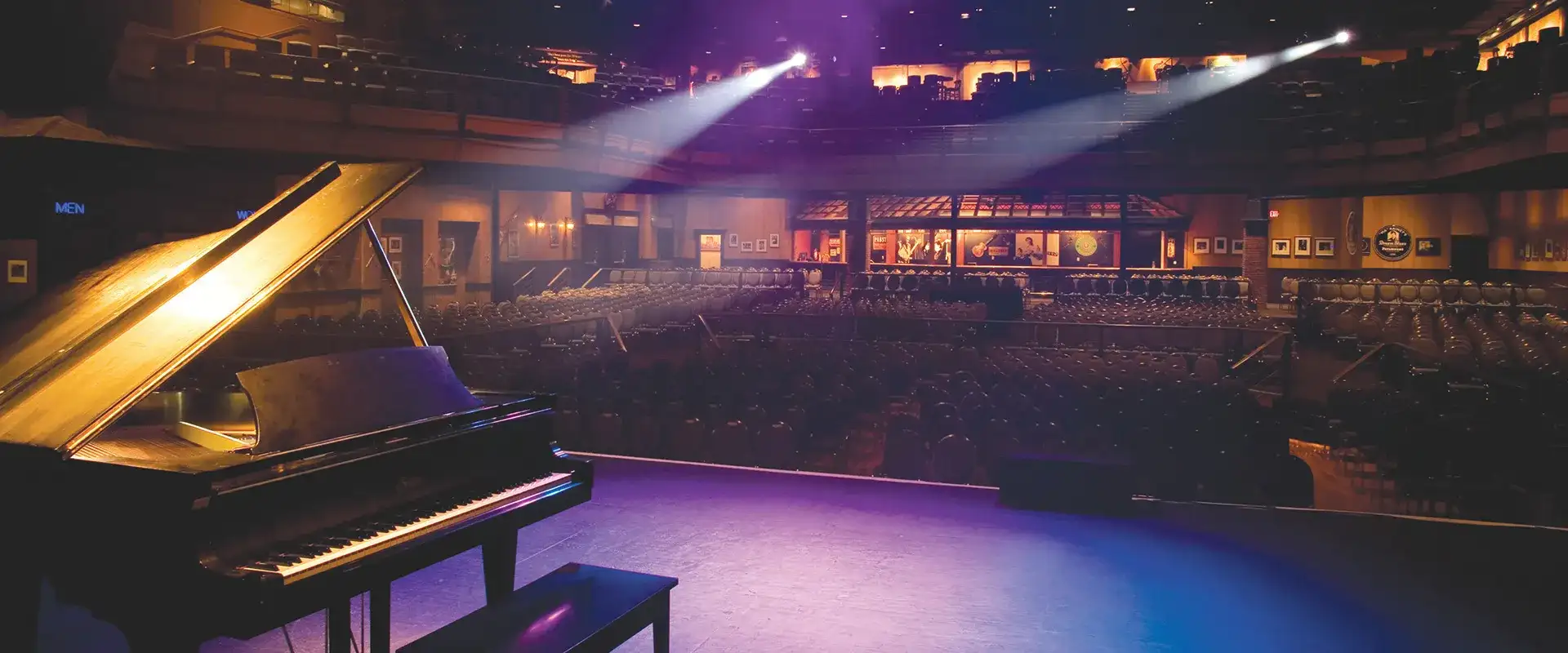 Bluesville Showcase Nightclub stage with piano, looking out to venue seating.